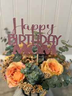 a happy birthday cake topper with roses and succulents in a vase