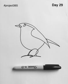 a drawing of a bird sitting on top of a piece of paper next to a marker