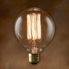 an old fashioned light bulb on a brown background