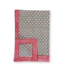 a red and green dish towel on a white background