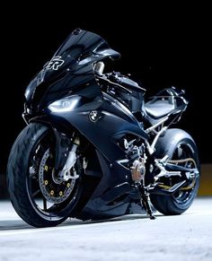 a black motorcycle parked on top of a parking lot