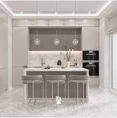 a modern kitchen with marble counter tops and bar stools