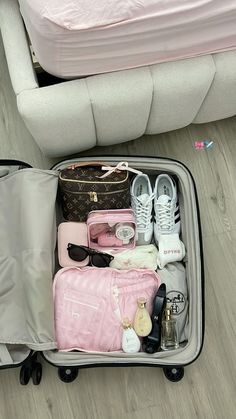 an open suitcase filled with personal items on the floor