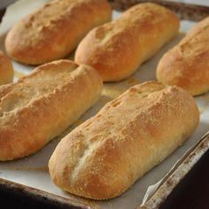 several loaves of bread sitting on top of a pan