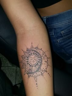 a woman's arm with a tattoo on it and a sun in the middle