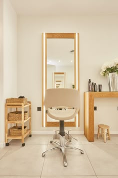 a chair in front of a mirror and some stools