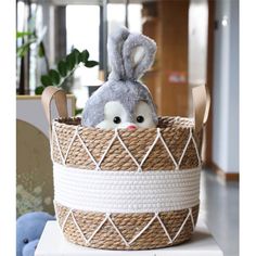 a stuffed animal in a basket on top of a table