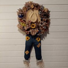 a cowboy hat hanging from the side of a wall with sunflowers on it