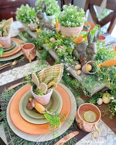 the table is set with carrots, greens and bunnies for an easter dinner