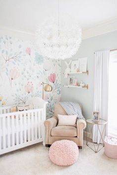 a baby's room with floral wallpaper and a white crib