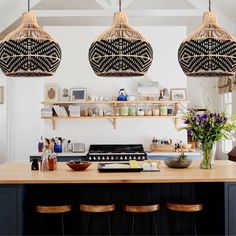 three hanging lights above a kitchen island