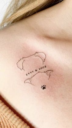 a woman with a tattoo on her chest that says, good night and dog paw prints