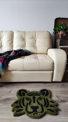 a living room with a couch and rug on the floor