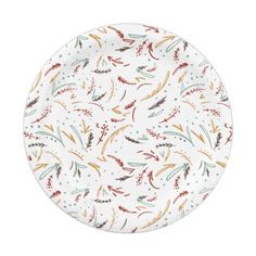 a white plate with red, orange and green feathers on it's rims