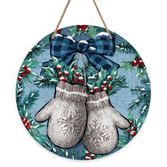 a blue christmas ornament with two mittens hanging from it's side