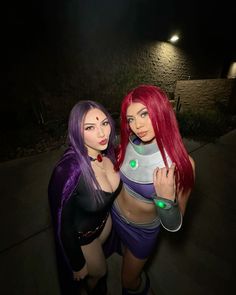 two women dressed in costumes standing next to each other