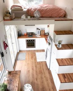 a tiny house with stairs leading up to the bedroom and living room, as seen from above