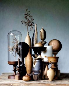 an assortment of vases and other items on a table