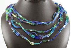 a multi strand beaded necklace on a mannequin