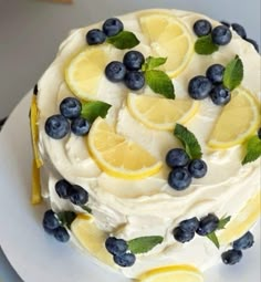 a cake with lemon slices and blueberries on it