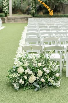 an outdoor ceremony set up with white chairs and flowers