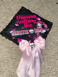 a graduation cap that says, this was nothing like monster high