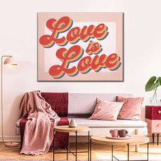 a living room scene with focus on the couch and love is love sign above it