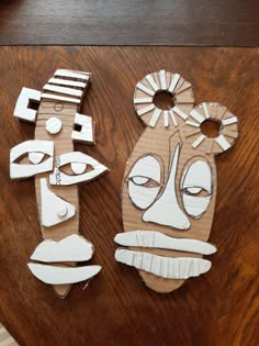 two pieces of paper cut out to look like faces