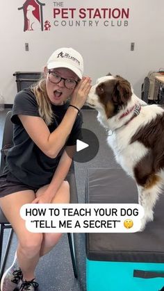 a woman sitting in front of a dog on top of a chair with her mouth open