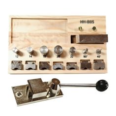 an assortment of metal tools are displayed on a wooden board with screws and nuts