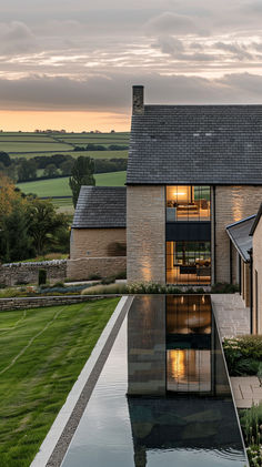 a house with a pool in front of it and grass on the ground next to it