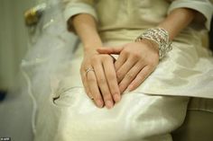 the bride and groom are holding hands on their wedding day, while they sit together