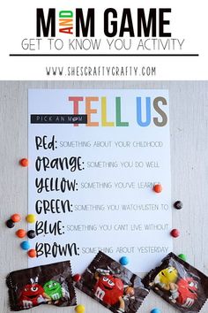 candy bar game with the words tell us on it and some candies in front