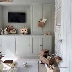 a living room filled with lots of furniture and decor on top of a white rug