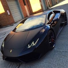 a black sports car parked in front of a building