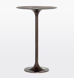 a small round table with a metal base and an iron plate on the top, against a white background