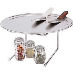 a silver tray with spices and spoons on it