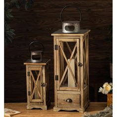 two wooden lanterns sitting next to each other