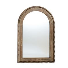 an arched wooden mirror on a white background