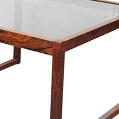 a wooden table with glass top and metal frame on the bottom, against a white background