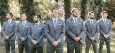 a group of men in suits standing next to each other