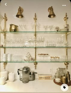 the shelves are filled with glassware and other kitchen items, including coffee cups on them