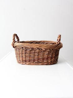 a wicker basket sitting on top of a white table