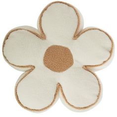 a white and brown flower shaped rug