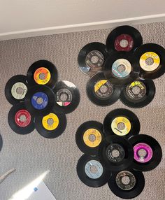 many different colored records are hanging on the wall