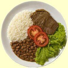 a white plate topped with rice and beans next to meat, lettuce and tomatoes