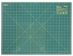 a green cutting mat with a ruler on it