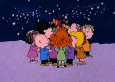 a group of children standing in the snow with their hands on each other's heads