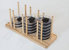 there are many cups with wooden sticks in the holder