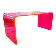 an orange and pink glass desk against a white background in the shape of a rectangle